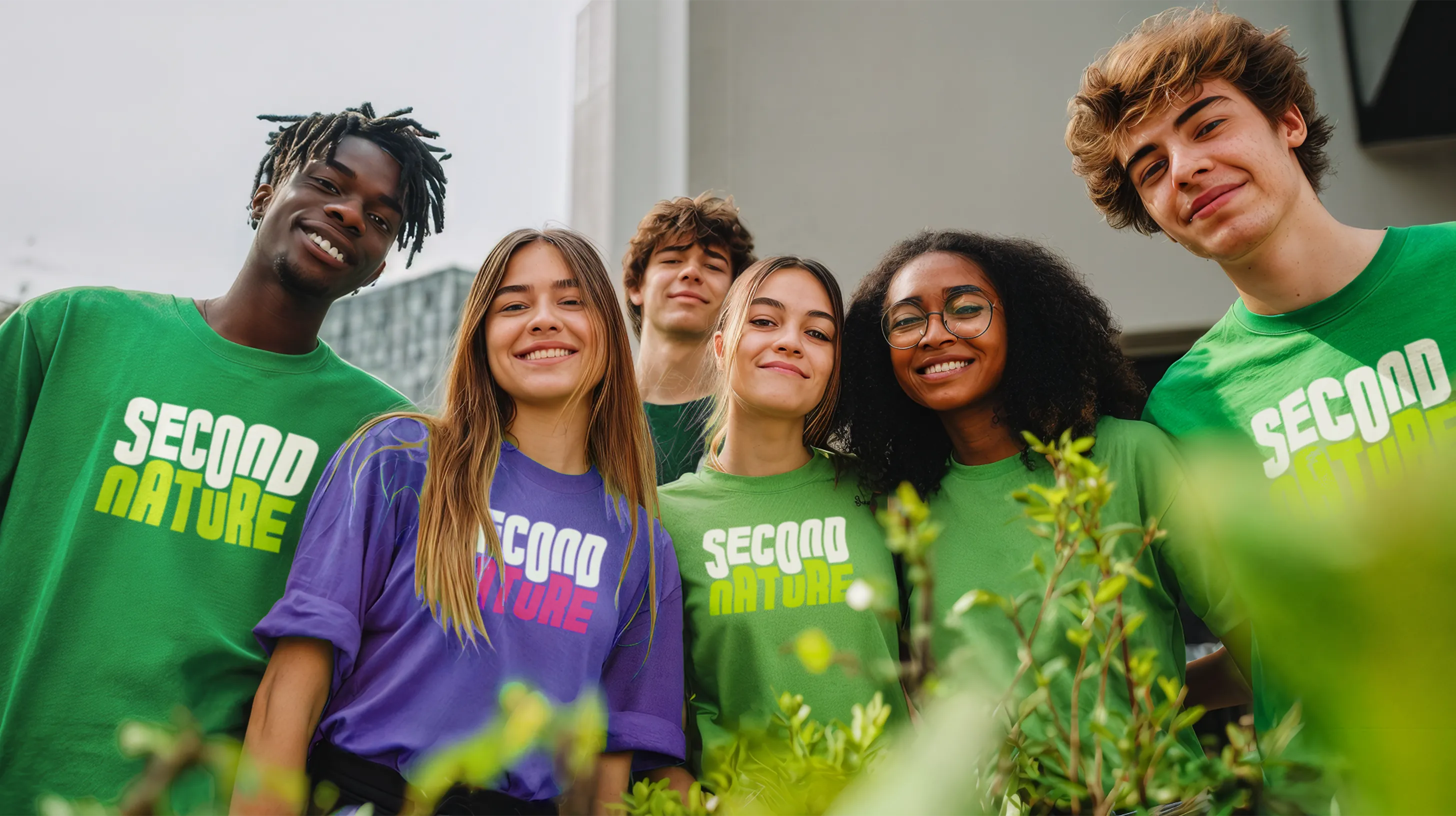 Young adults smiling in Second Nature merch